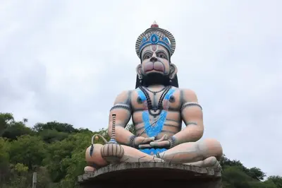 a large statue sitting on top of a building at Vara Farm in Kanakapura