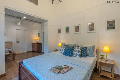 a bedroom with a bed with a blue comforter at EKOSTAY - Casa Del Sol in Ooty