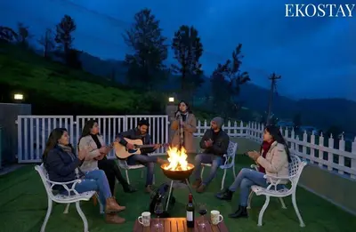 a group of people sitting around a fire at EKOSTAY - Dutch Cottage in Ooty