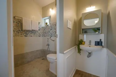 a bathroom with a toilet and a sink at EKOSTAY - Dutch Cottage in Ooty