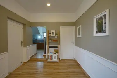 a hallway of a home with wooden floors and a door at EKOSTAY - Dutch Cottage in Ooty