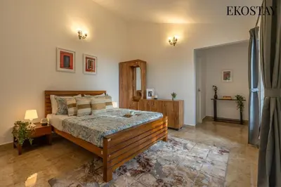 a bedroom with a large bed in a room at EKOSTAY - Skyfall Mist Villa in Ooty
