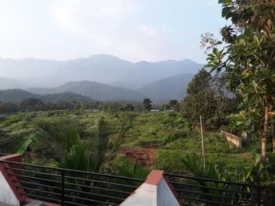 a view of a valley with mountains in the distance at SriMahi Farmhouse in Agali