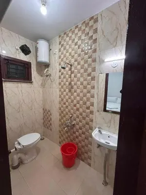a bathroom with a toilet and a sink at Shivvs Leisure Rooms & Villa Ooty in Ooty