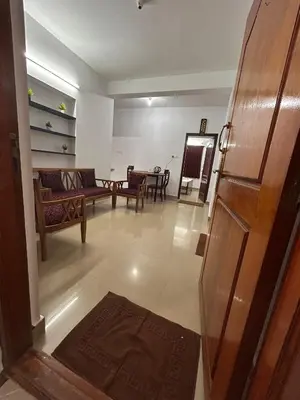 a living room with a couch and a table at Shivvs Leisure Rooms & Villa Ooty in Ooty