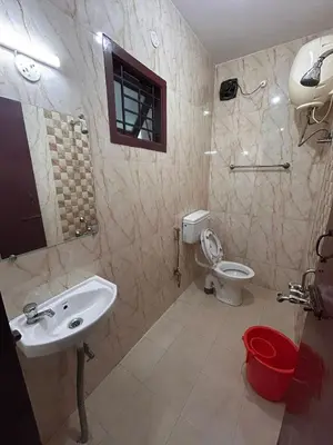 a bathroom with a sink and a toilet at Shivvs Leisure Rooms & Villa Ooty in Ooty