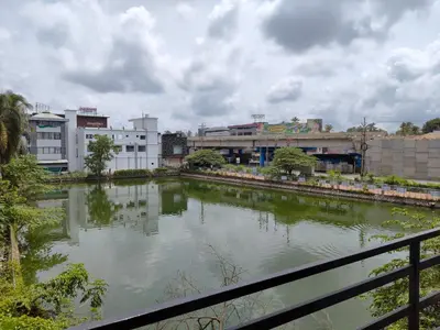 a river in a city with buildings at Queens INN in Kodungallūr