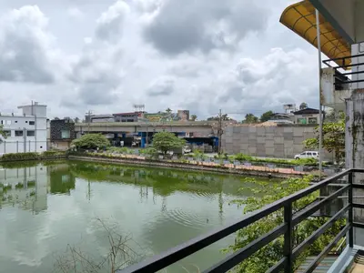 a view of a river with buildings in the background at Queens INN in Kodungallūr