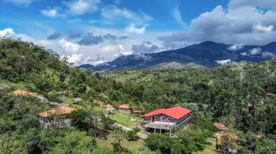 an aerial view of a house on a mountain at Zacs Valley Resort & Wellness Retreat Kodaikanal in Kodaikānāl