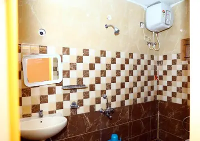 a bathroom with a sink and a mirror at JJ Homes in Ooty