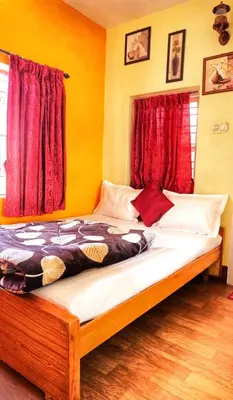 a bedroom with a large bed with red curtains at Winterfell Park in Ooty