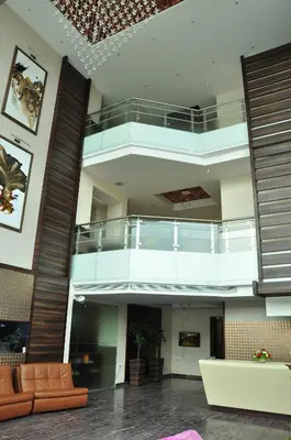 a large lobby with a staircase in a building at Hotel Atrium in Erode