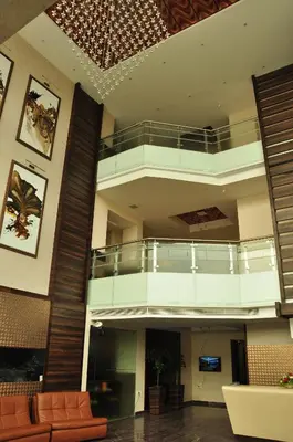 a large lobby with a staircase in a building at Hotel Atrium in Erode