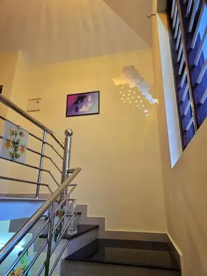 a staircase in a house with a cloud on the wall at Tranquil Nest Villa - 4BHK Villa - Entire Villa stay in Wayanad in Kalpetta