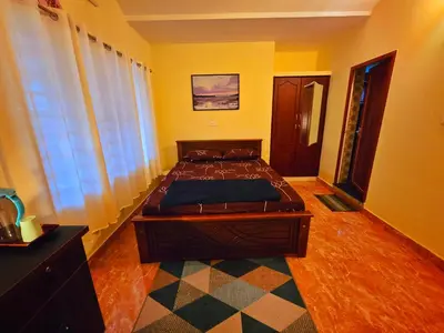 a bedroom with a large bed in a room at Tranquil Nest Villa - 4BHK Villa - Entire Villa stay in Wayanad in Kalpetta