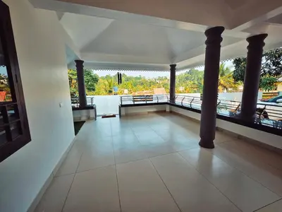 a room with columns and a view of the water at Tranquil Nest Villa - 4BHK Villa - Entire Villa stay in Wayanad in Kalpetta