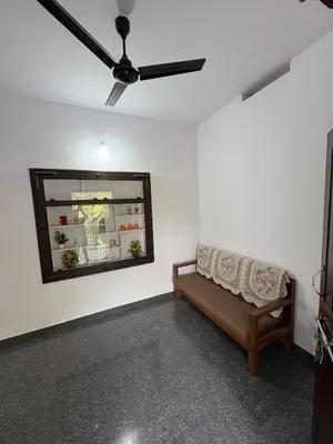 a living room with a couch and a ceiling fan at Anchery homes in Trichūr