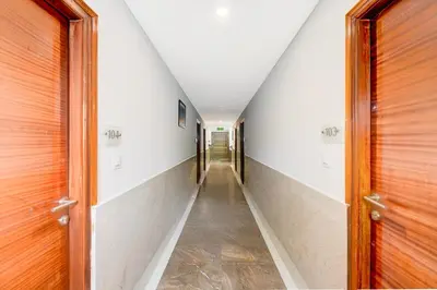 a hallway with doors and a long corridor at Super Townhouse Oak Sri Mahadeshwara Convention Centre Formerly Shri Aprameya Resort in Mysore