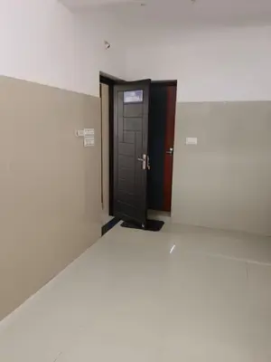 an empty hallway with a black door and a wall at Kerala Ayurveda and yoga for women sn in Ernakulam