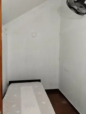 a white room with a bed in it at Pariyarathu veedu, 4 Bed Hostel in Wayanad