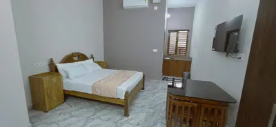 a bedroom with a bed and a television in a room at Alanchery Residency in Cheruthuruthi