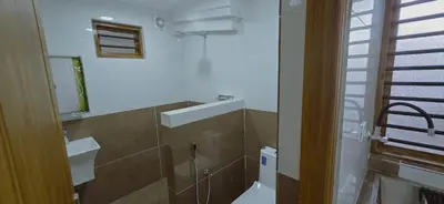 a bathroom with a toilet and a sink at Alanchery Residency in Cheruthuruthi