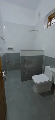 a bathroom with a toilet and a sink at Alanchery Residency in Cheruthuruthi