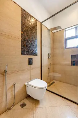 a bathroom with a toilet and a shower at Punya Farms - Luxury 5BR near Isha Yoga in Alāndurai