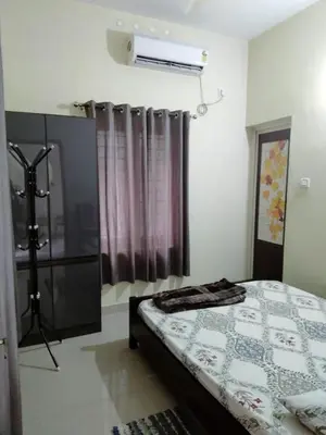 a bedroom with a bed and a shower in it at Peaceful Vacation Home Near the City in Cochin