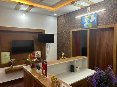 a room with a television and a podium with a lectern at Sreedevi Gardens in Irikkūr