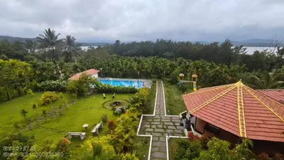 an aerial view of a resort with a swimming pool at Coorg Riverness Resort in Kushālnagar