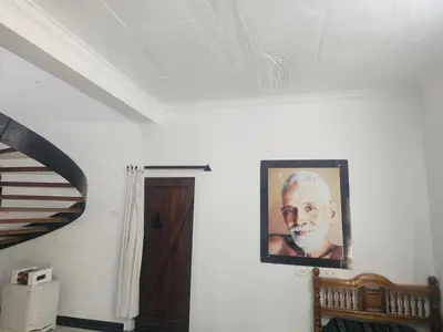 a picture of a man on a wall in a room at Shiva Shambo Home Stay - Entire Villa in Coimbatore