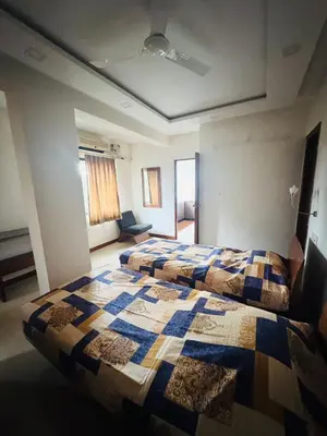 a bedroom with two beds in a room at Fully furnished 2BHK apartment near Gokulam in Mysore