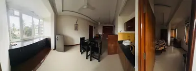 a hallway of a building with a kitchen and a living room at Fully furnished 2BHK apartment near Gokulam in Mysore