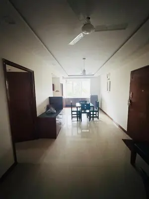 an empty room with a dining table and chairs at Fully furnished 2BHK apartment near Gokulam in Mysore