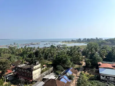 an aerial view of a town with a river and buildings at Ocean View 4 BHK Apartment in Kannur