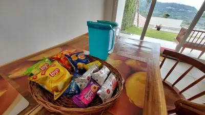 a table with a basket of chips and snacks on it at Mayfield Valley Homestay in Kotagiri