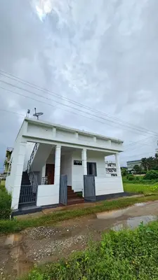 a small white building with a porch at NAMERA Serviced Apartments in Gonikoppal