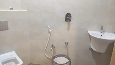 a bathroom with a toilet and a sink at Hotel Maharajas in Kāmānayakkanpālaiyam