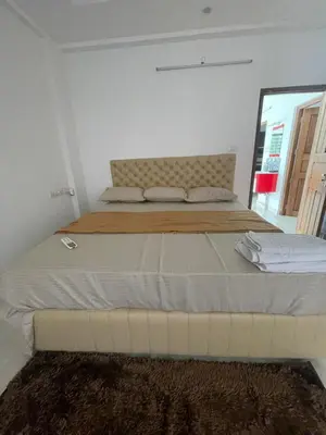 a bedroom with a large bed in a room at SREE CHAKRA Tourist Home Guruvayoor in Guruvāyūr