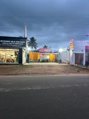 a group of shops on the side of a street at Aryas comforts near Gumbaz in Shrīrangapattana