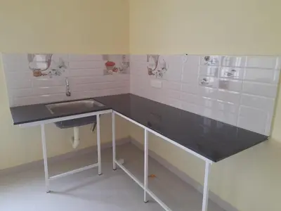 a bathroom with a black counter and a sink at Mannath Home Stay in Alwaye