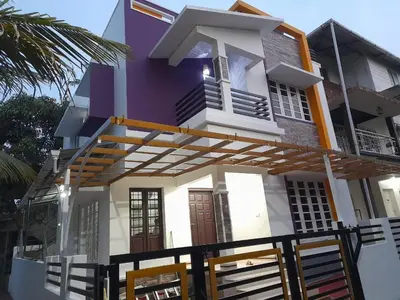 a purple and white house with a porch at Mannath Home Stay in Alwaye
