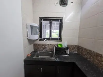 a small kitchen with a sink and a window at Serene Steps in Coimbatore