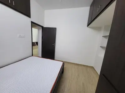a small room with a bed and a mirror at Serene Steps in Coimbatore