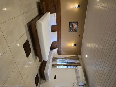 a bathroom with a stack of towels at Suraksha Suites in Mysore