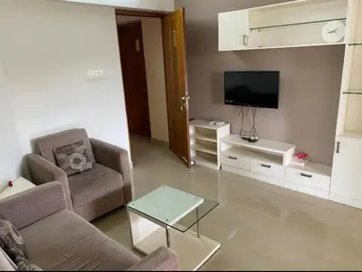 a living room with a couch and a tv at View 360 in Kozhikode