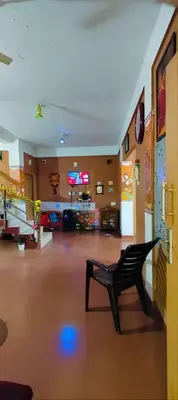 a empty lobby with a black bench in a room at Tejana villa in Mananthavady