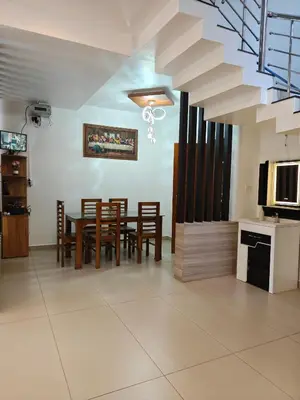 a kitchen and dining room with a table and chairs at Full Home Wayanad Bathery in Sultan Bathery