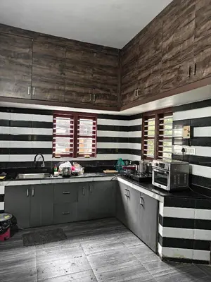 a kitchen with black and white stripes on the walls at Full Home Wayanad Bathery in Sultan Bathery
